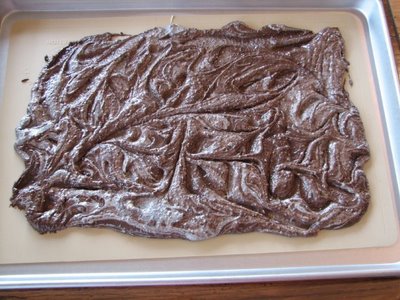 melted chocolate cookie bark on parchment paper