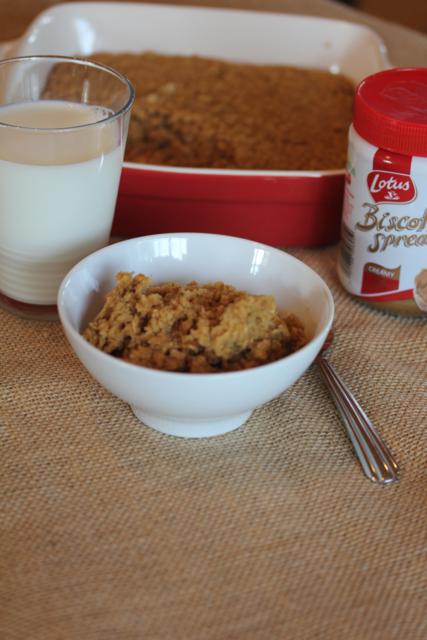 baked oatmeal in a white bowl with milk and biscoff