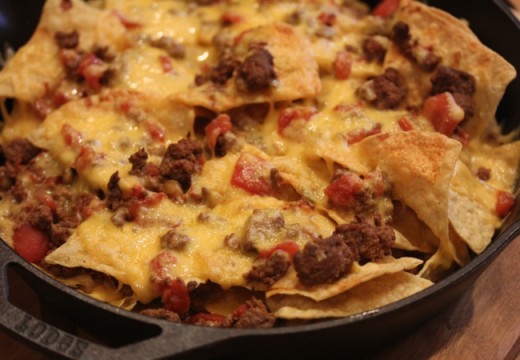 nachos with chili in cast iron pan