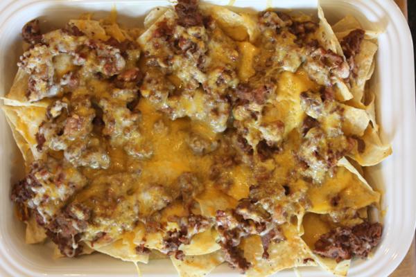 sausage nachos in white pan