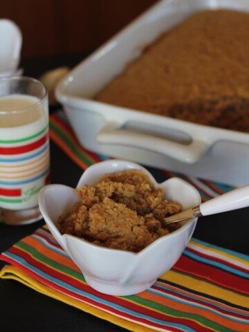 Peanut Butter Baked Oatmeal in white bowl with milk