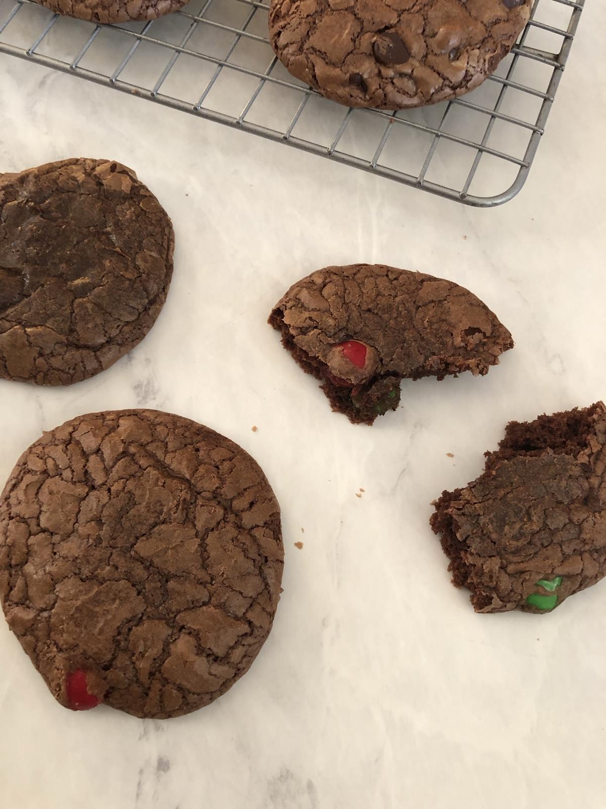 chocolate cookies with M&M's on a cooling rack