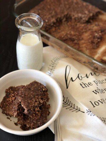 Double Chocolate Baked Oatmeal in white bowl with a glass of milk