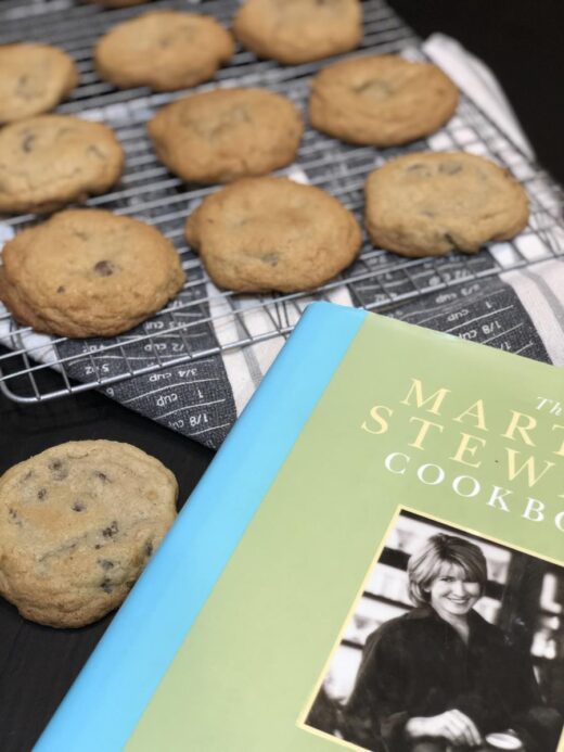 Cookies on a cooling rack next to a Martha Stewart Cookbook