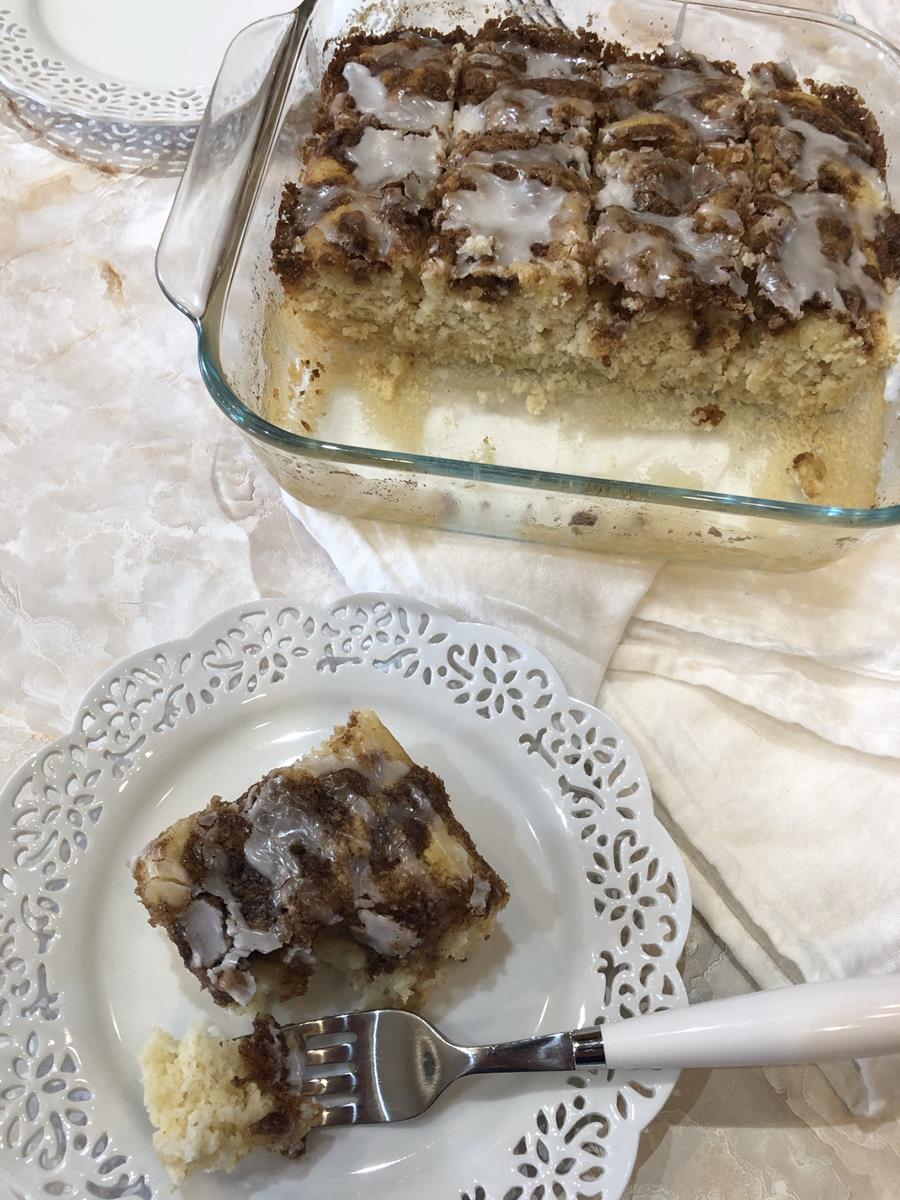 Cinnamon Roll Muffin Cake on a white plate next to cake pan