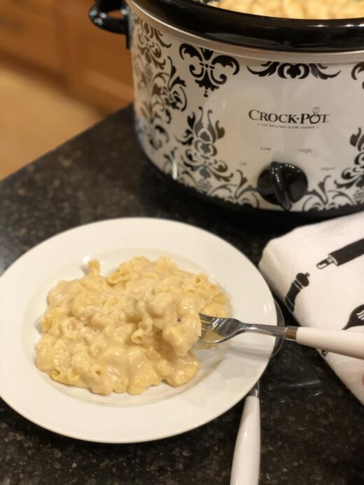 Martha Stewart Slow Cooker Mac and Cheese on a plate next to a crock pot