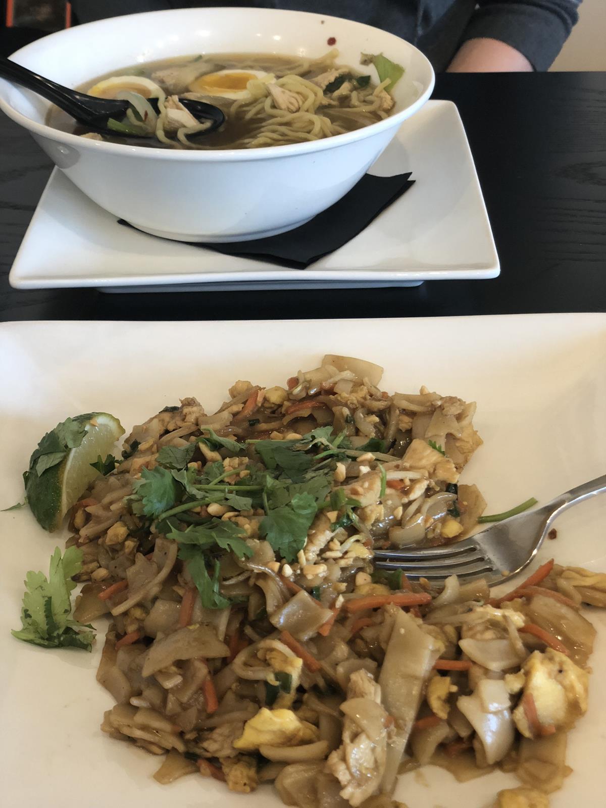 Pad Thai on plate and soup in a bowl