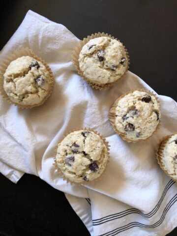 oatmeal muffins on white cloth and black counter