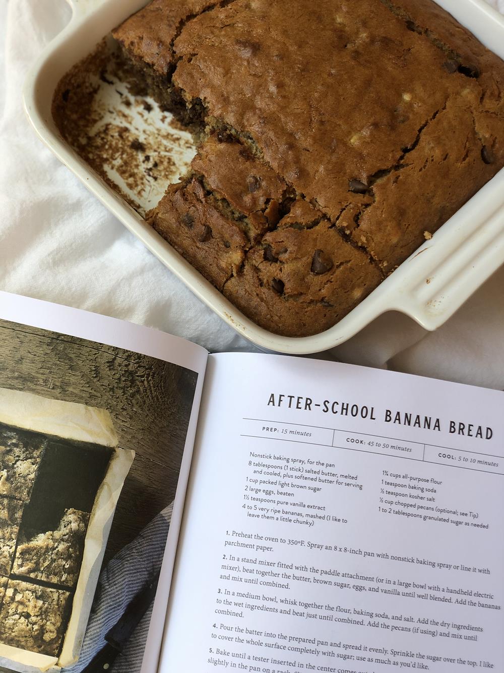 banana bread in a pan with cookbook