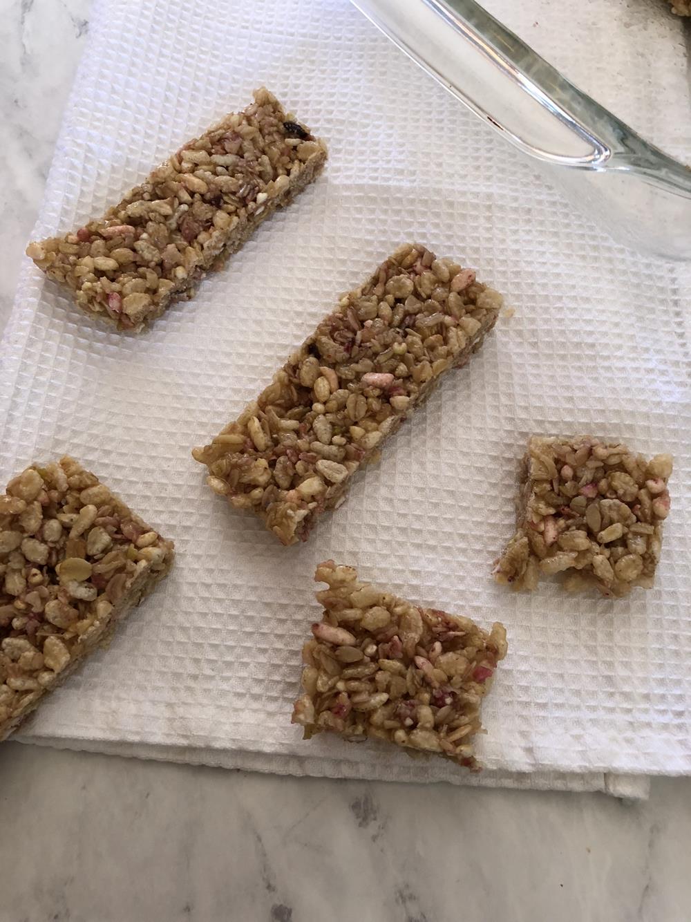 Homemade Granola Bars cut in half on white cloth