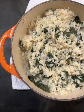 buttered rice with spinach in orange pot