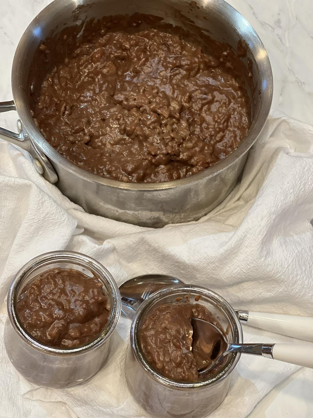 Chocolate rice pudding in bowl and pan