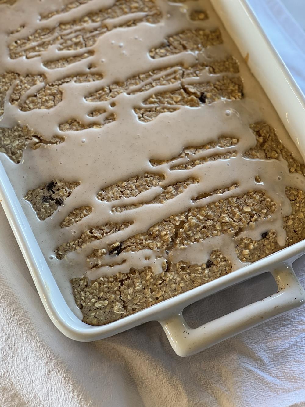 Cinnamon Raisin Baked Oatmeal in white baking pan