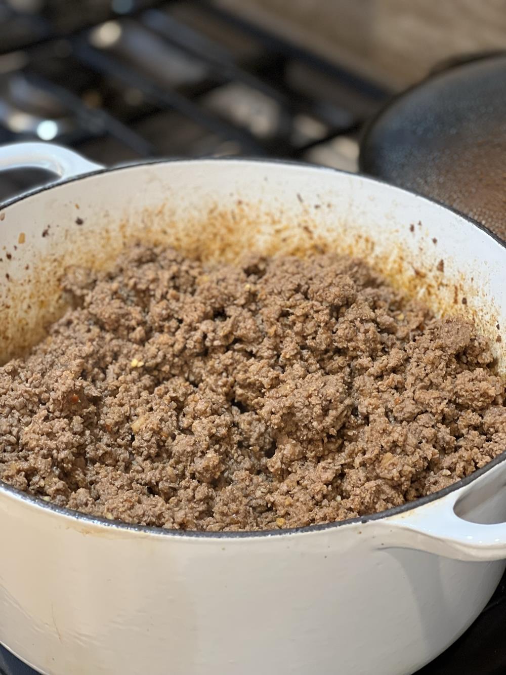 Taco meat cooking in a large white pot