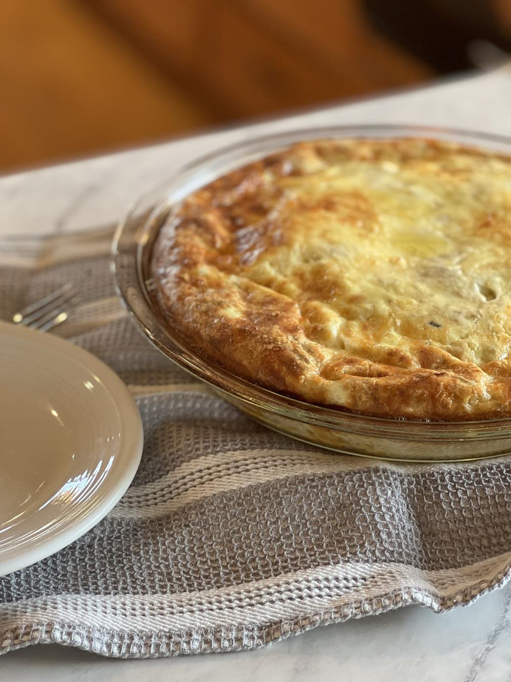 Crustless tuna quiche in pan on white counter