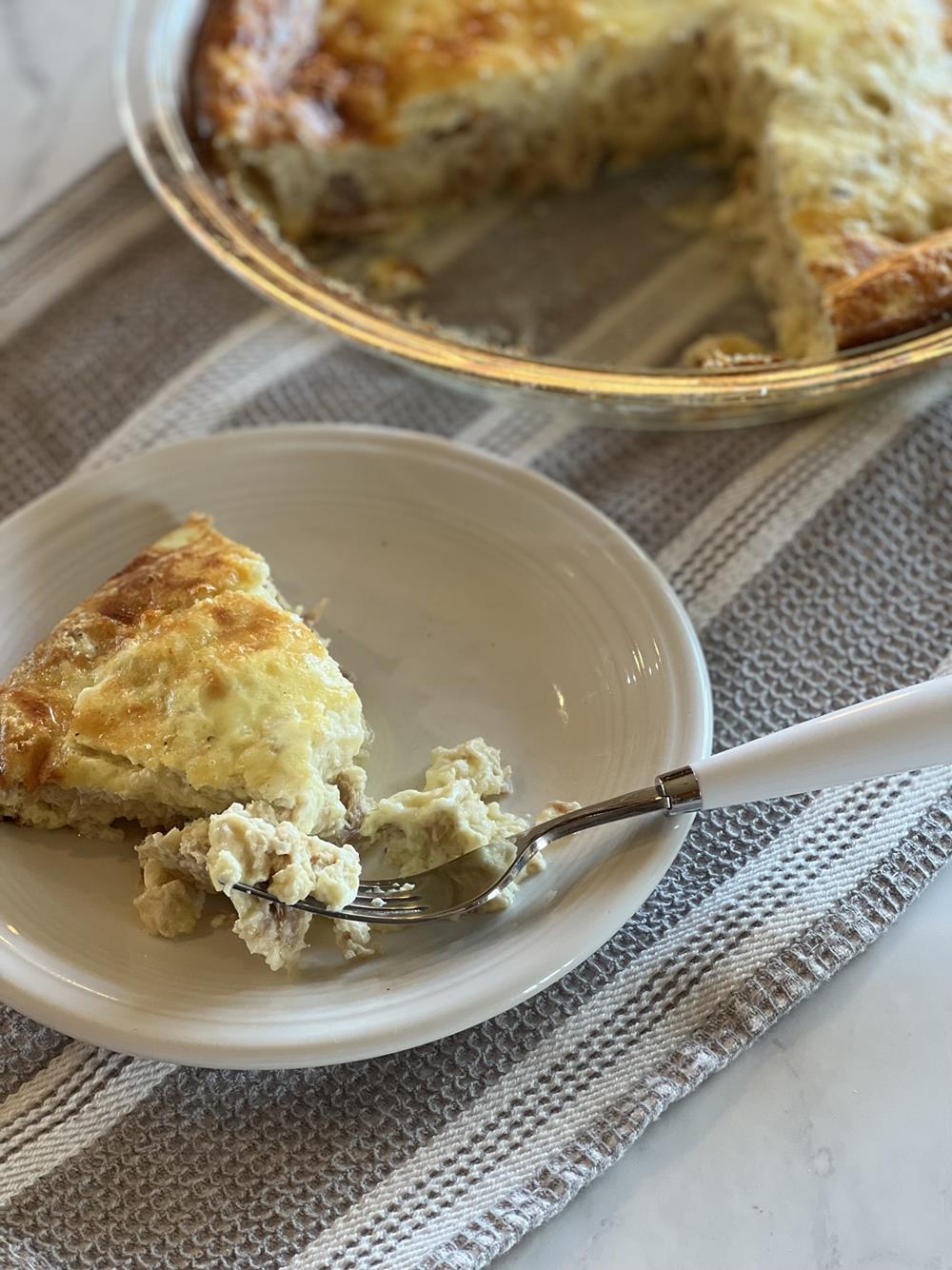 Crustless Tuna Quiche on white plate with fork