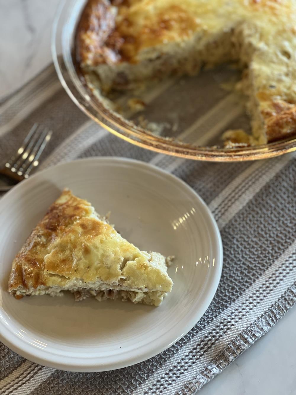 Tuna Quiche on white plate with pan in background