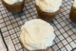 banana cupcakes with frosting on cooling rack