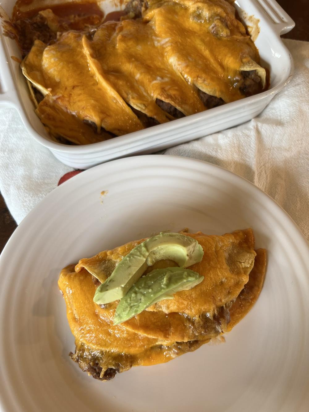 Fold Over Enchiladas on white plate with avocados
