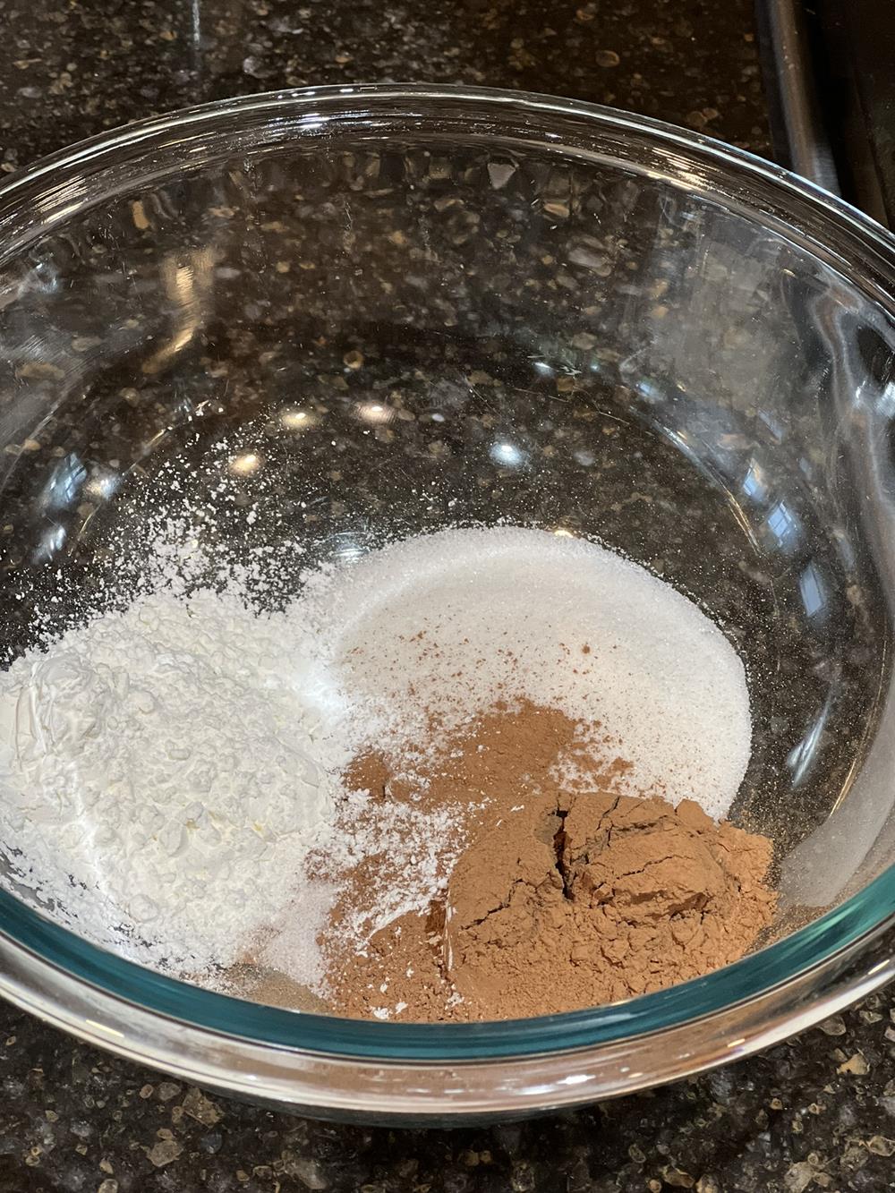 Chocolate pudding ingredients in glass bowl