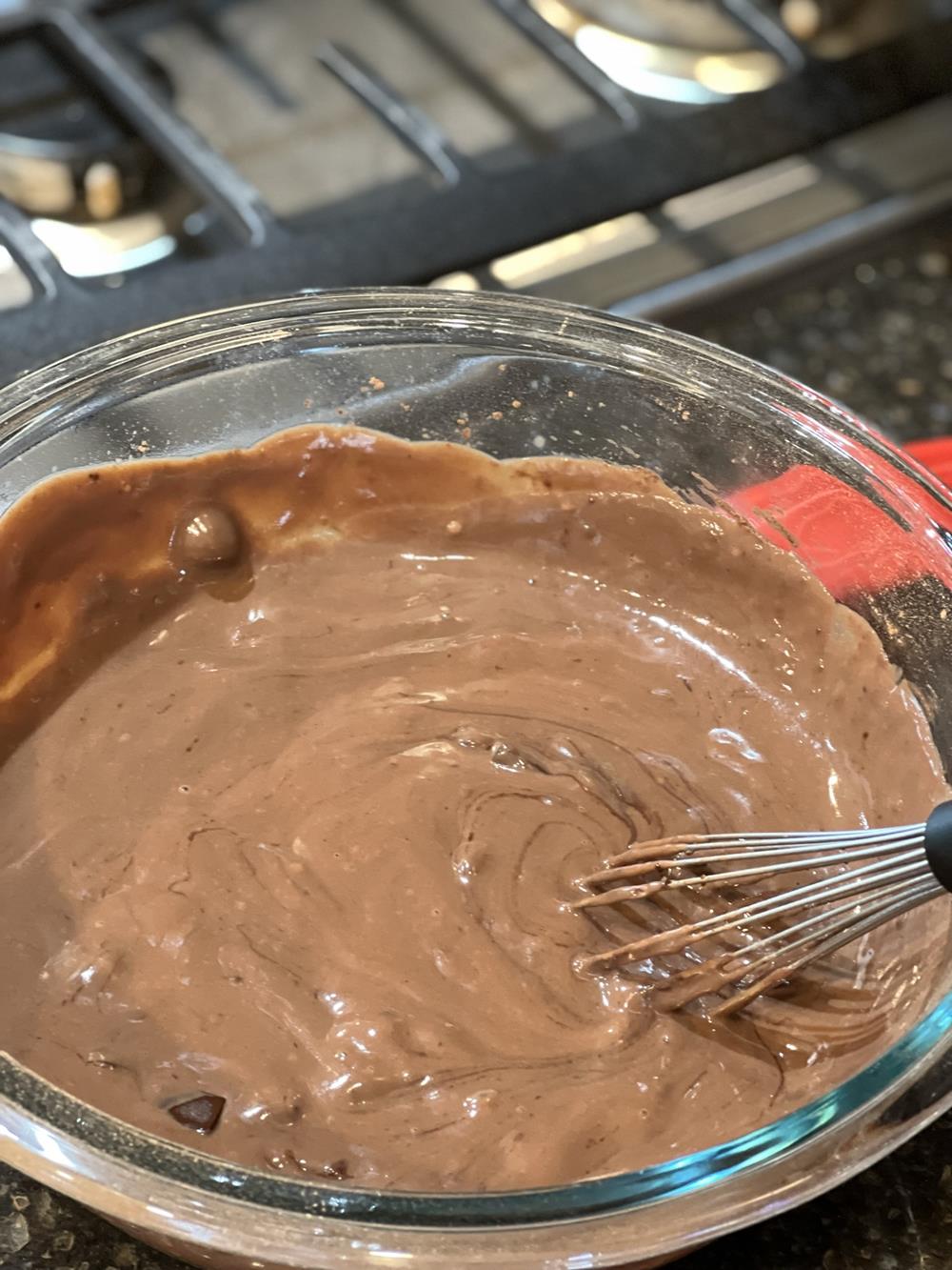 Chocolate Pudding in glass bowl with whisk
