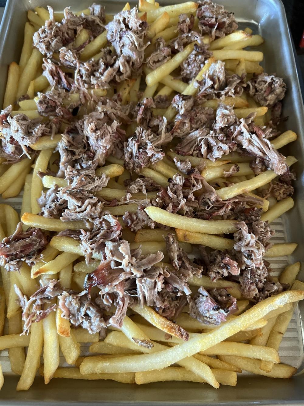 fries and meat on baking sheet