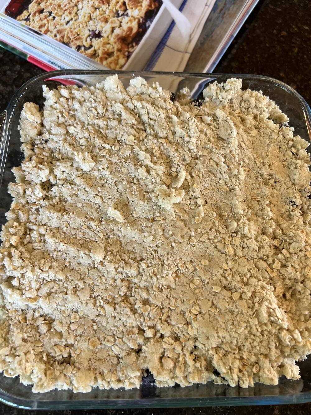 unbaked blueberry crisp in glass pan