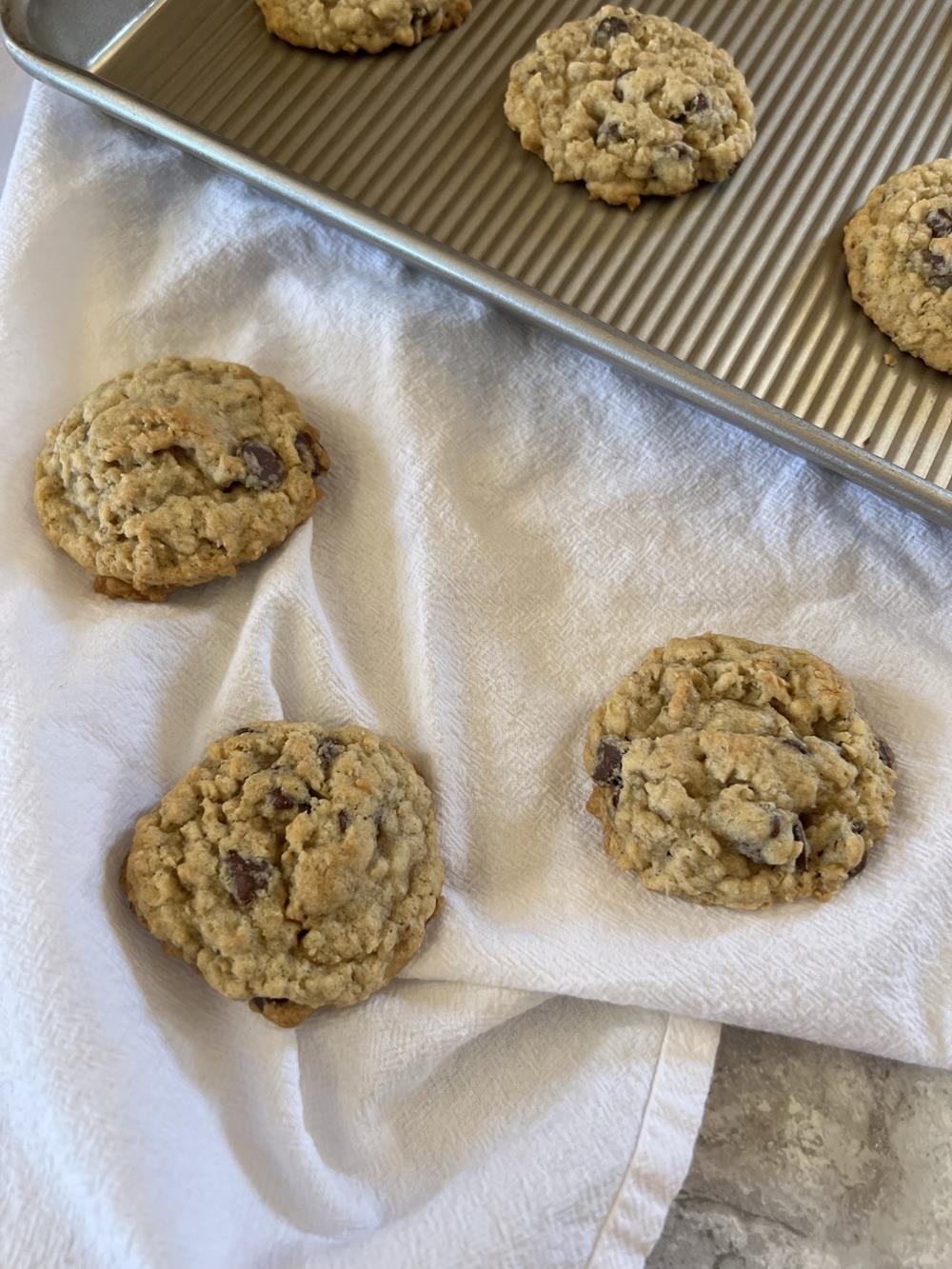Chocolate Chip Oatmeal Cookie Recipe on white napkin and on cookie sheet