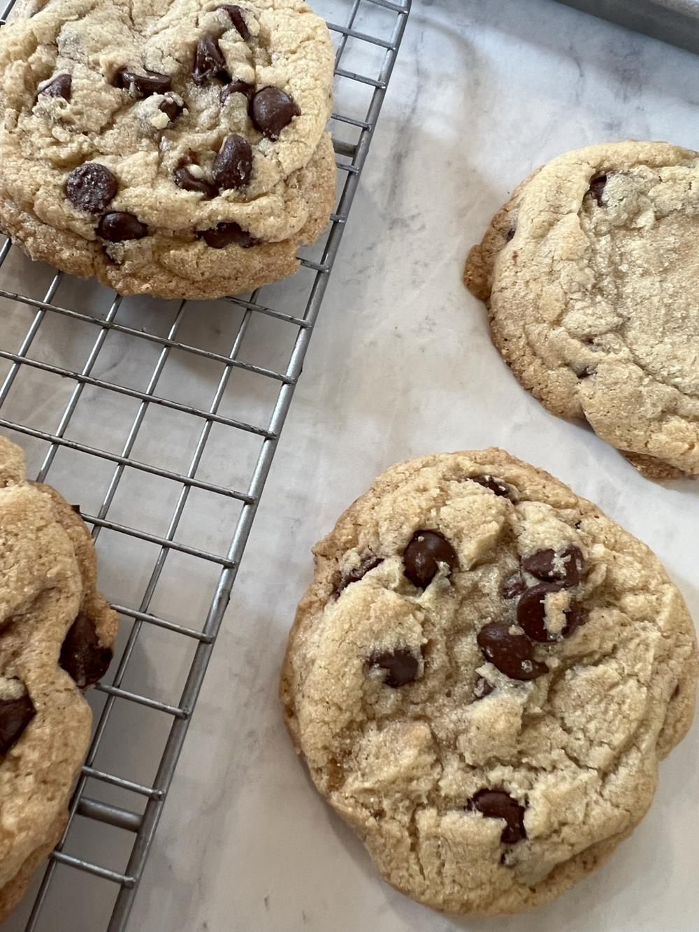 gluten free chocolate chip cookies on white marble and cooling rack