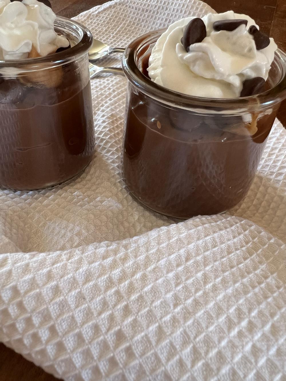 Peanut Butter Chocolate Pudding with Whipped Cream in glass jars