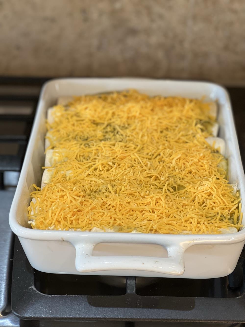 Chicken Enchiladas Creamy uncooked in white pan