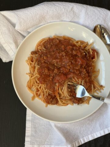 Crock Pot Spaghetti Sauce with pasta on white plate