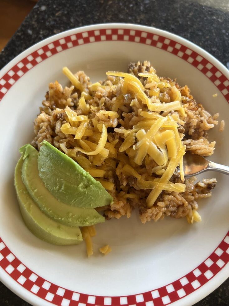 mexican rice with cheese on red and white plate