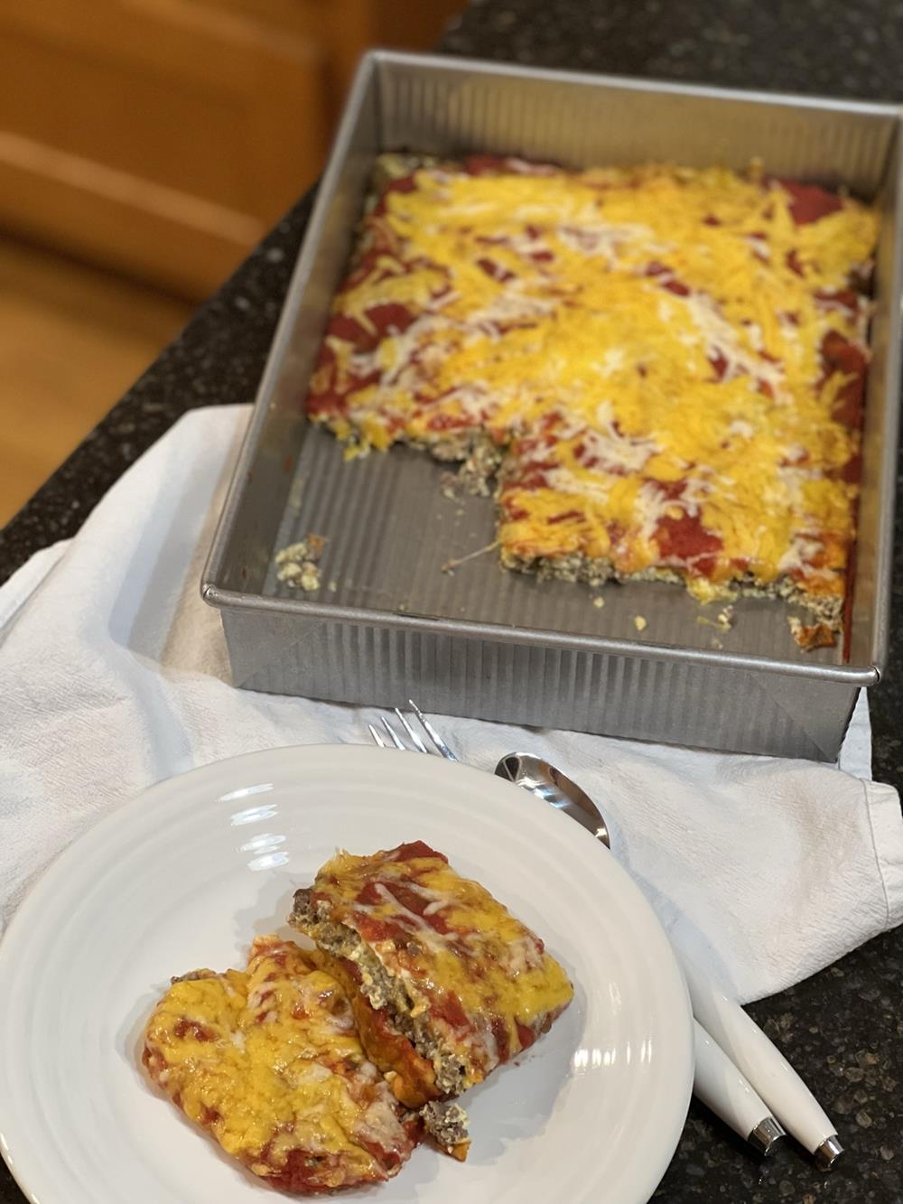 chili relleno casserole on white plate with baking dish in the background