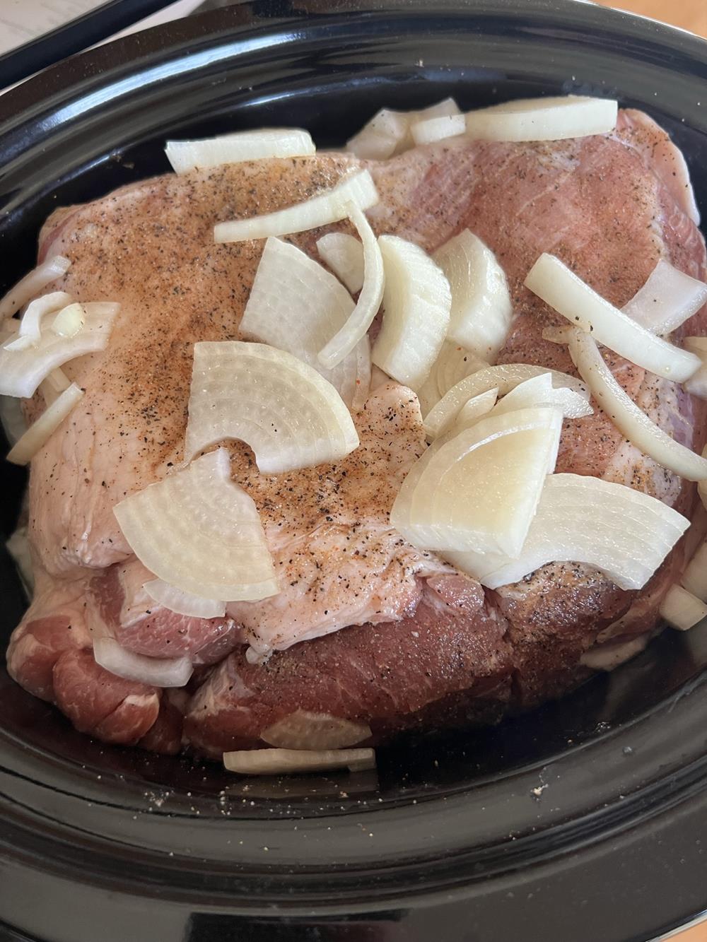 Raw Pork Roast in crock pot with onions