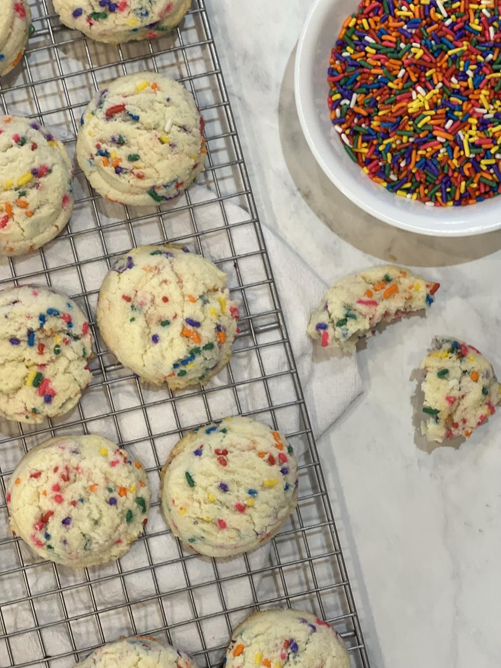 drop sugar cookies with sprinkles in the background