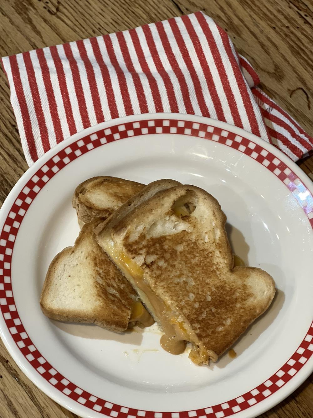 Grilled Peanut Butter and Cheese Sandwich Recipe on plate with red and white kitchen towel