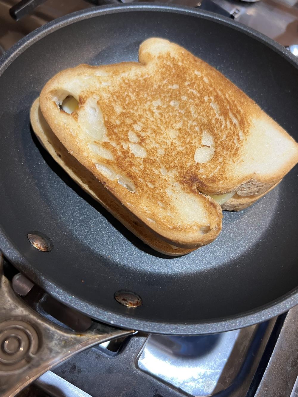 grilled peanut butter and cheese sandwich cooking in a pan
