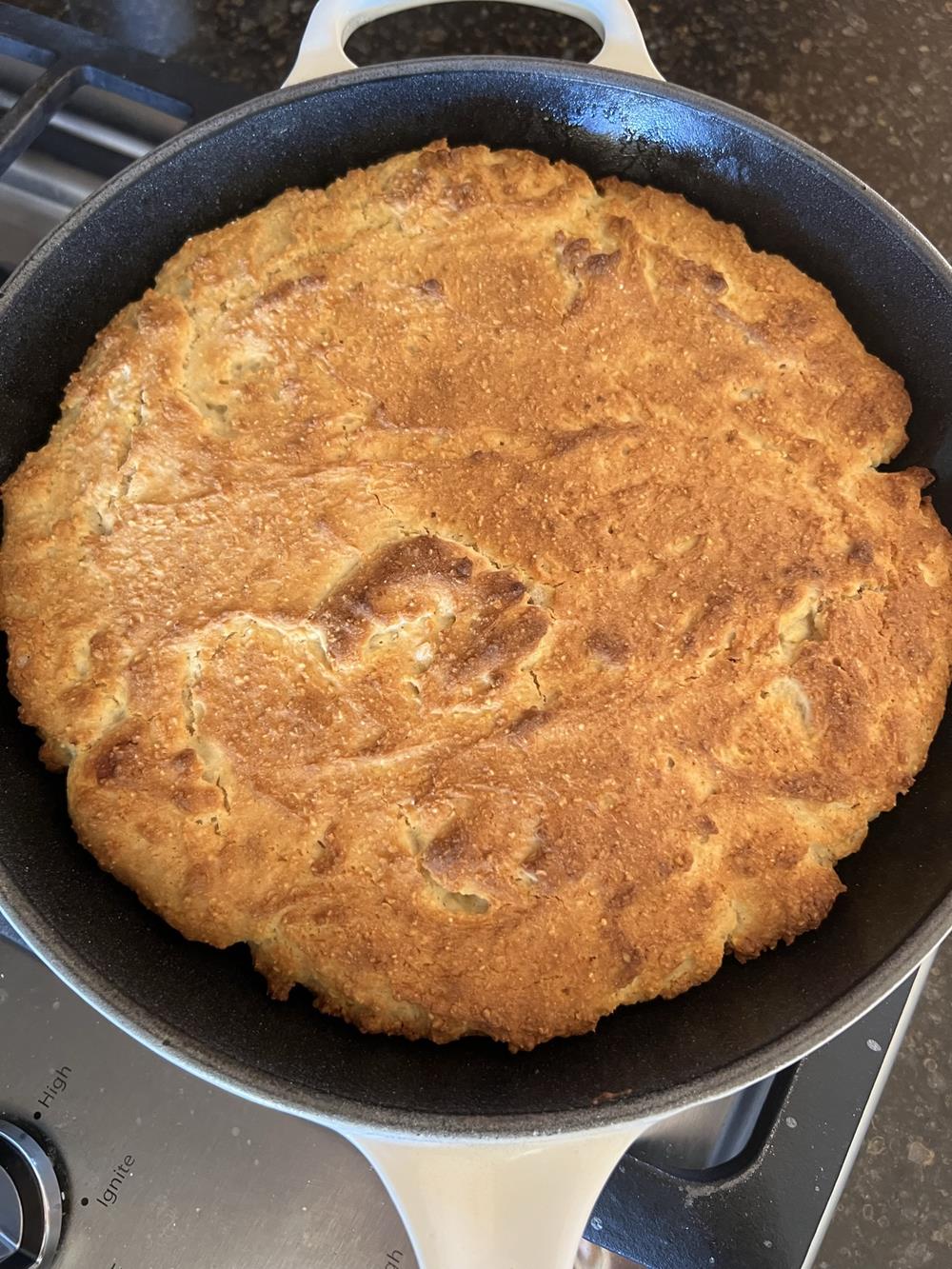cornbread in a cast iron pan on stove top