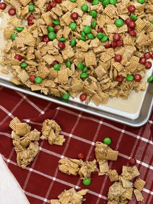Caramel Chex Mix Recipe with m&m's on cookie sheet and red napkin