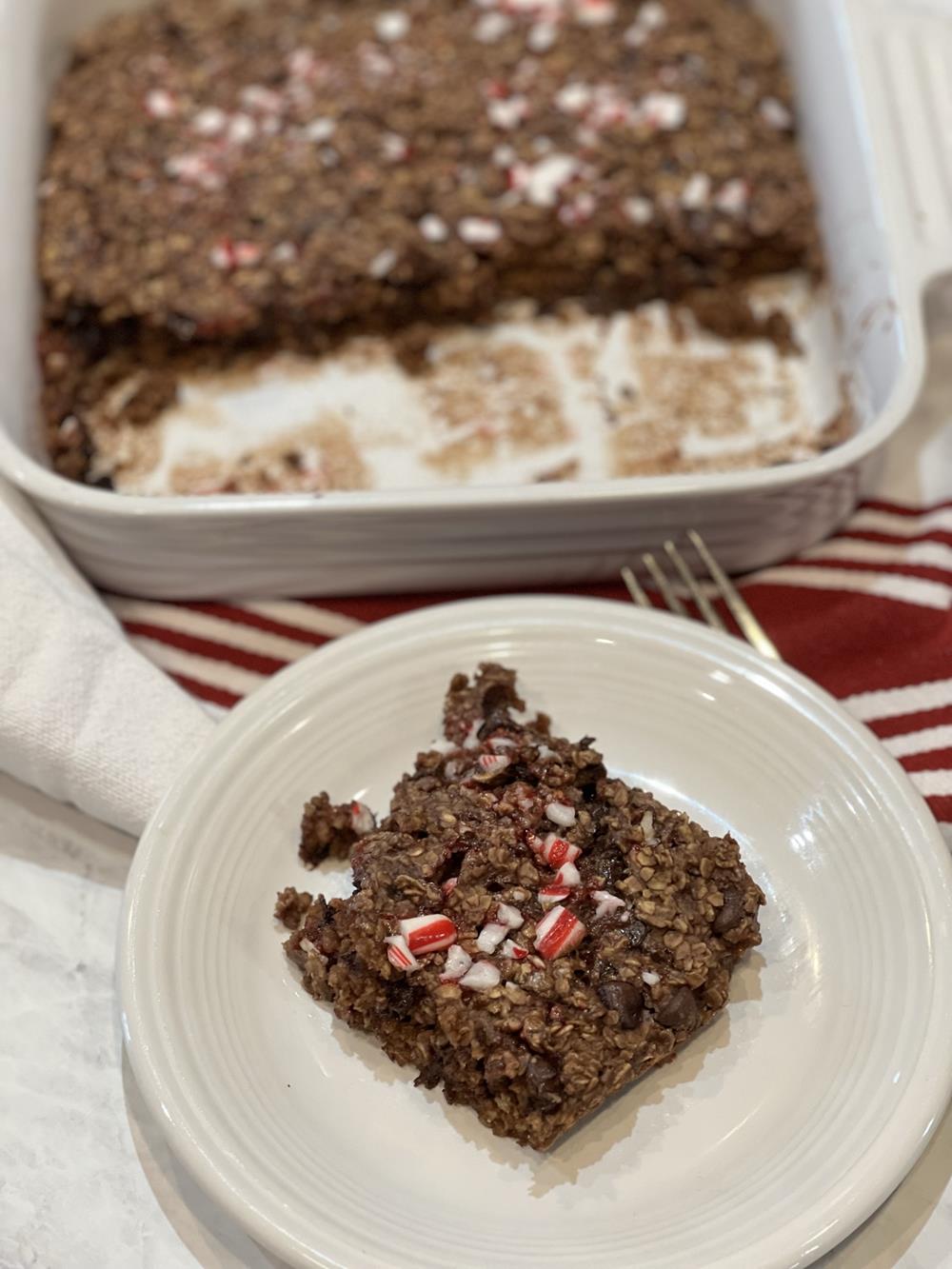 chocolate candy cane baked oatmeal cut into squares on a white plate