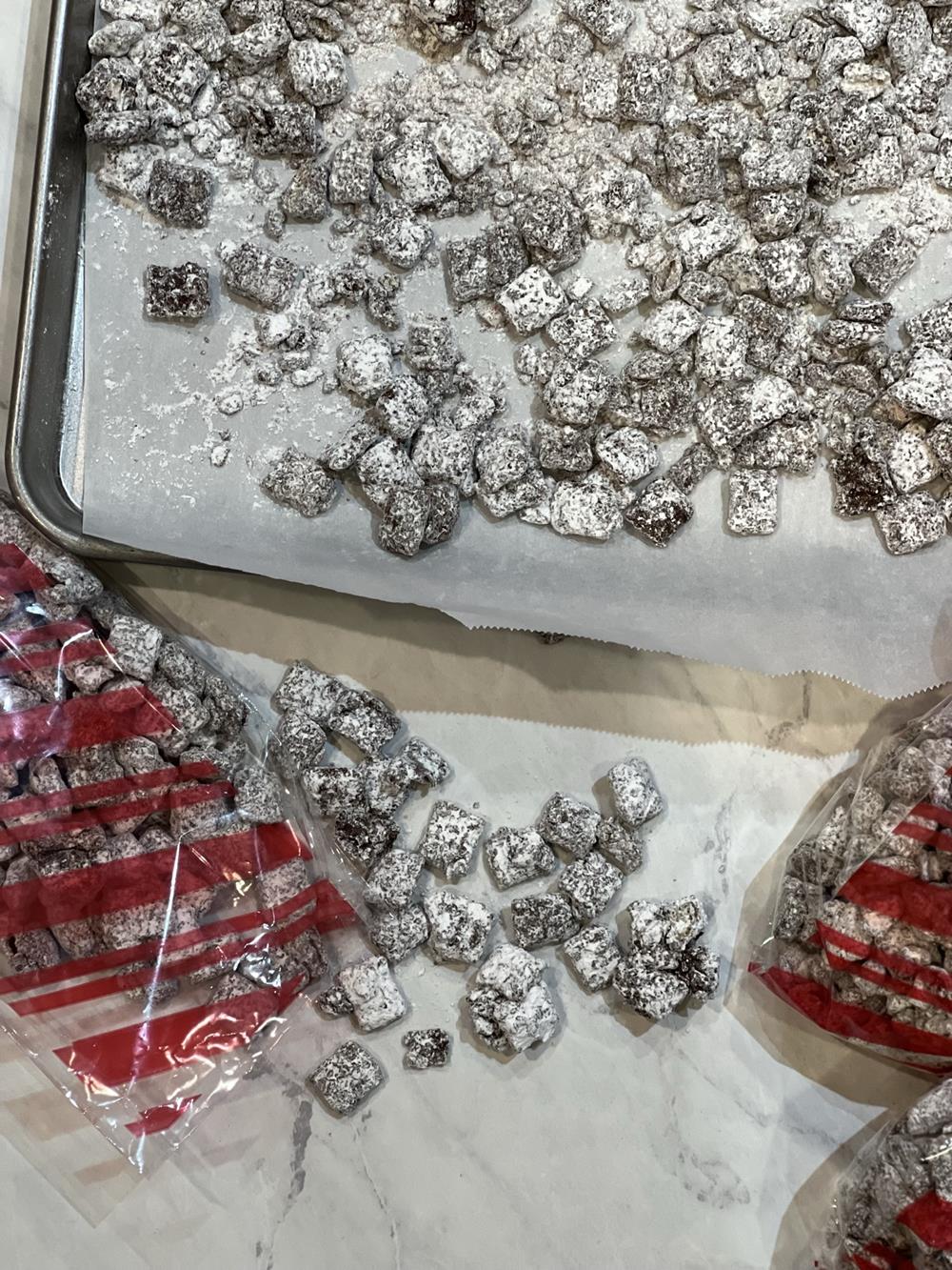 Chocolate Candy Cane Chex Mix on baking sheet with small bags in front