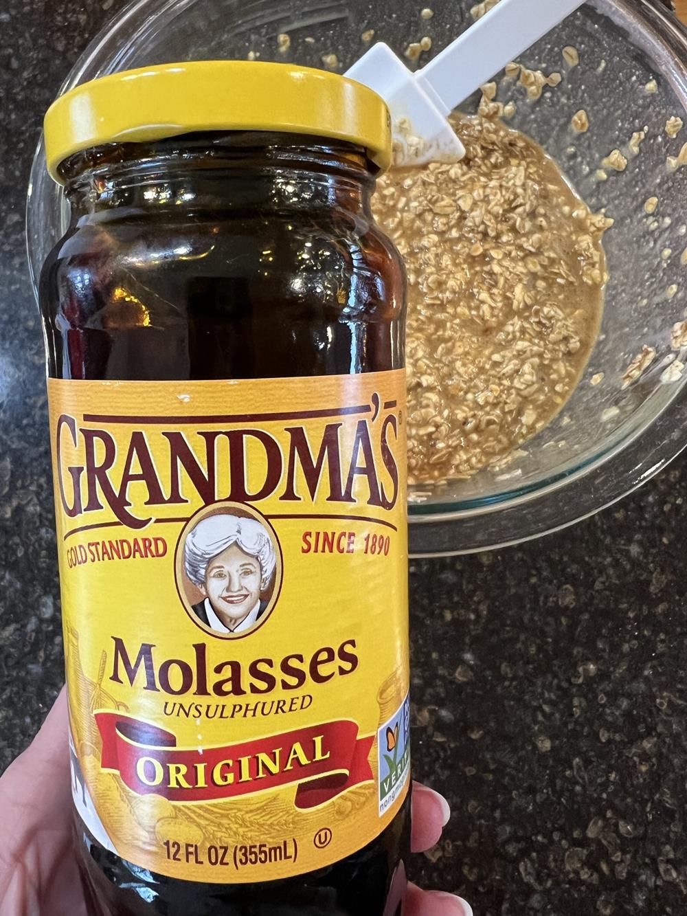 jar of molasses with bowl of oatmeal in background