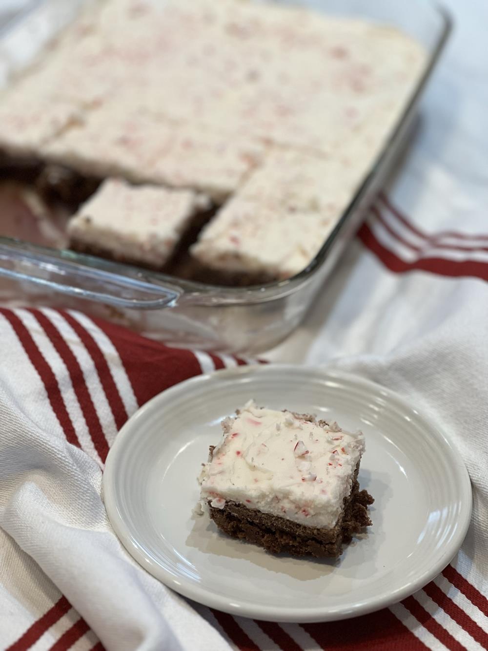 gluten free brownie on white plate with frosting