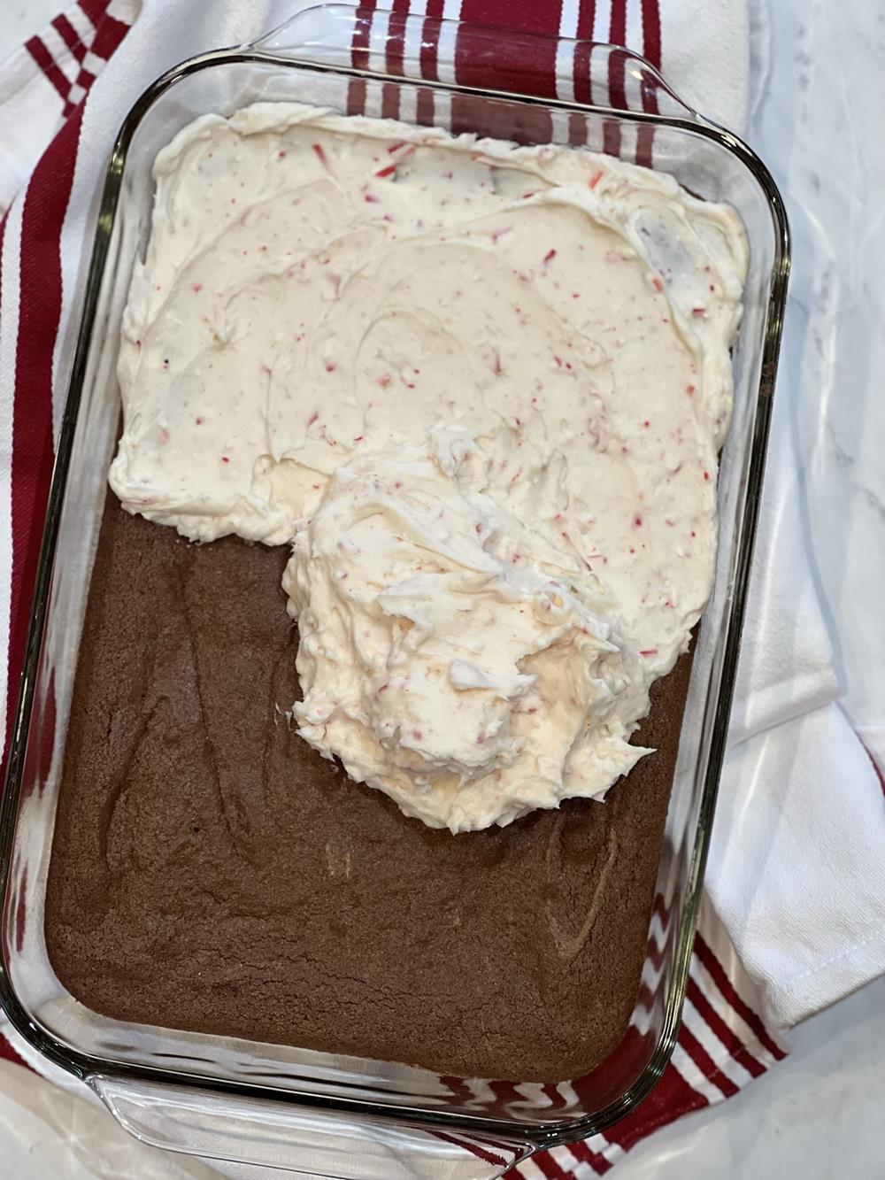 frosting on brownies in glass pan