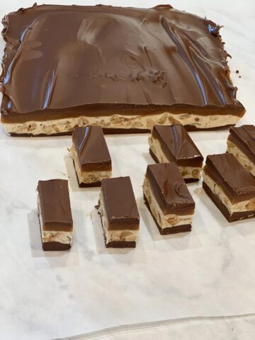 homemade snickers bars on parchment paper