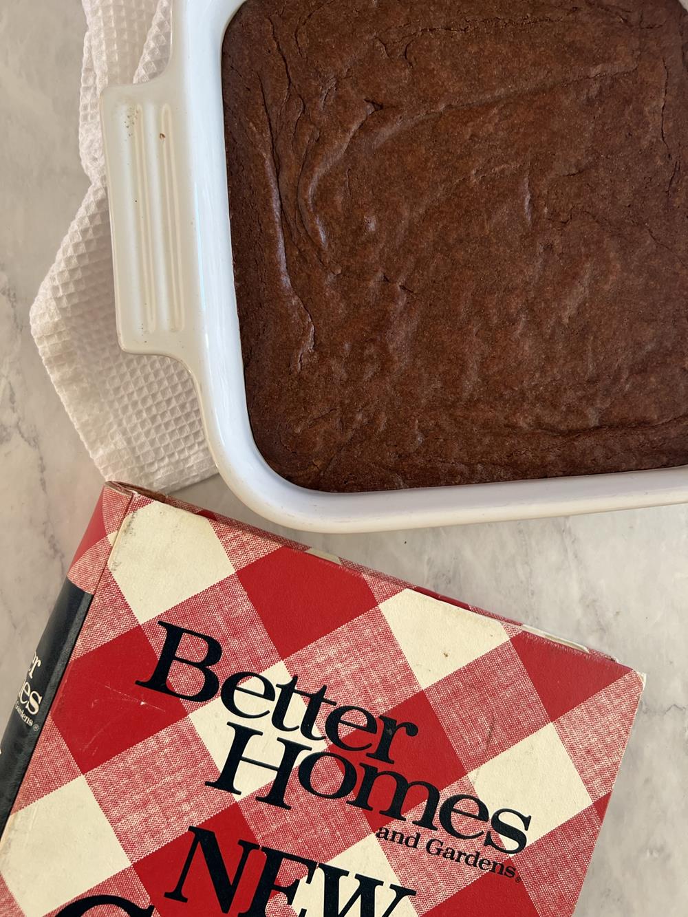 Better Homes and Garden cookbbok and a pan of brownies