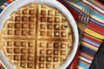 waffles on white plate and a striped napkin