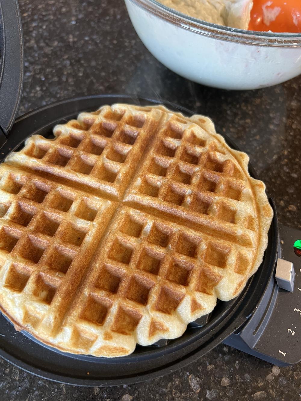 waffle cooking in a waffle maker