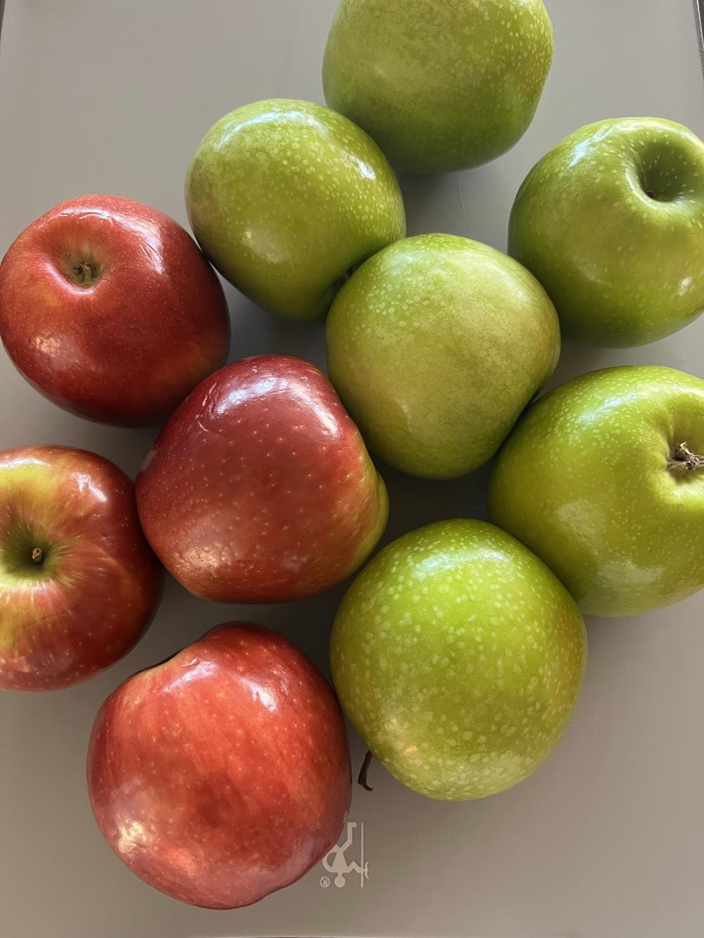 red and green apples on a counter